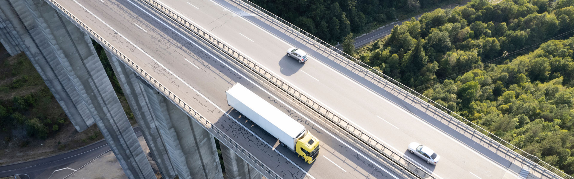 aerial view of truck and cars driving over highway