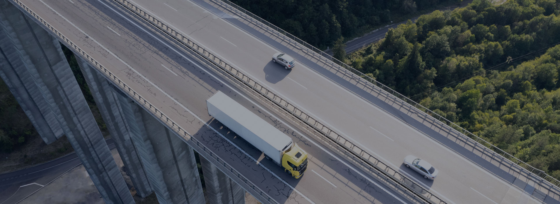 aerial view of truck and cars driving over highway