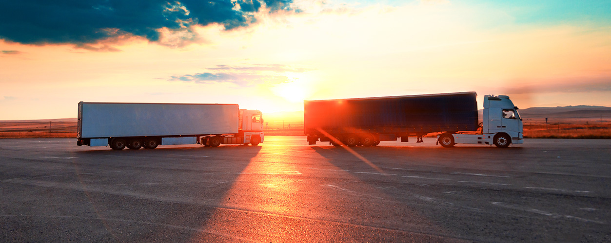 view of trucks with sunset in the background